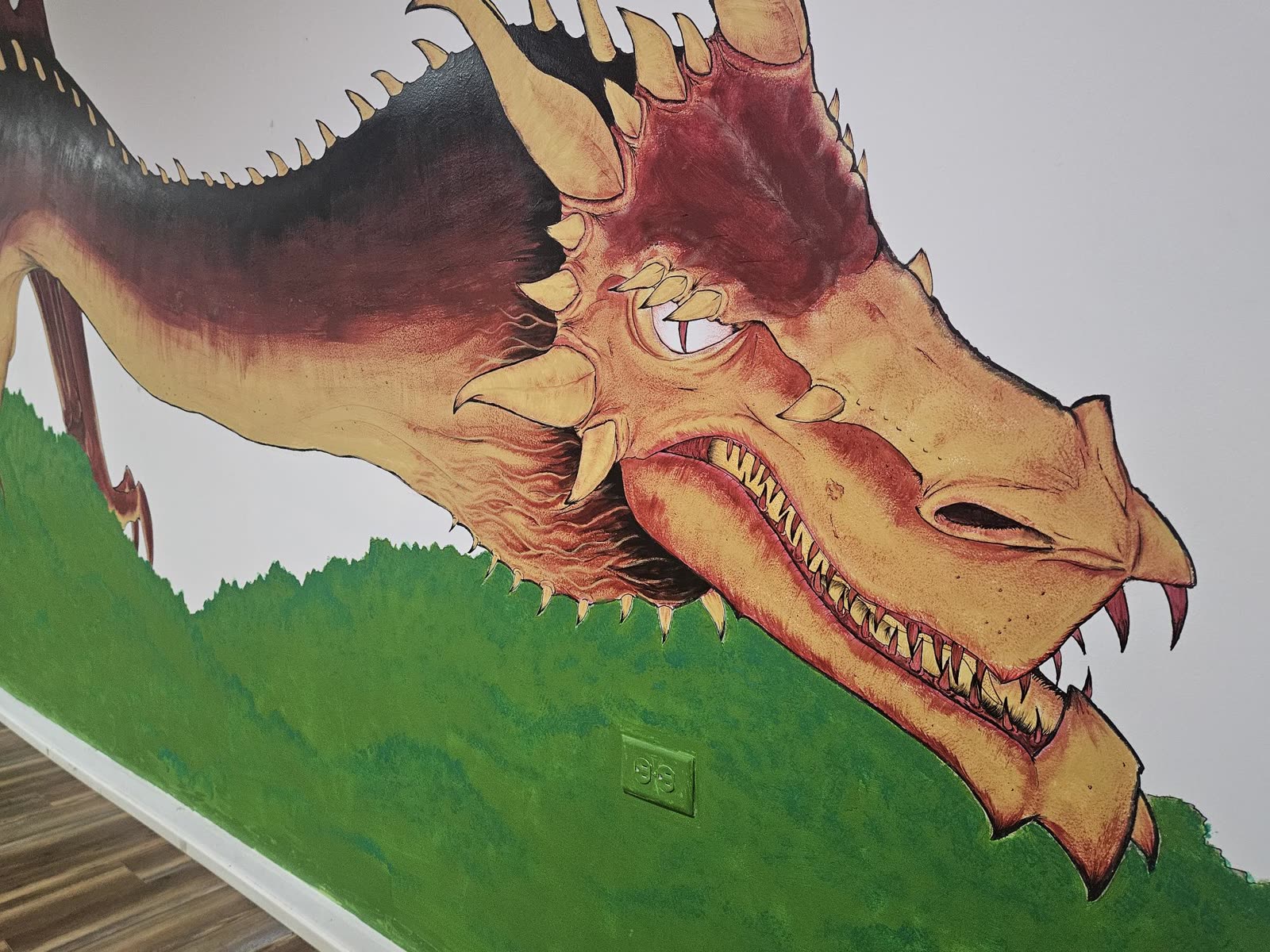 Hand-painted dragon mural on the wall inside Ragged Wizard dispensary in Lawton, Michigan
